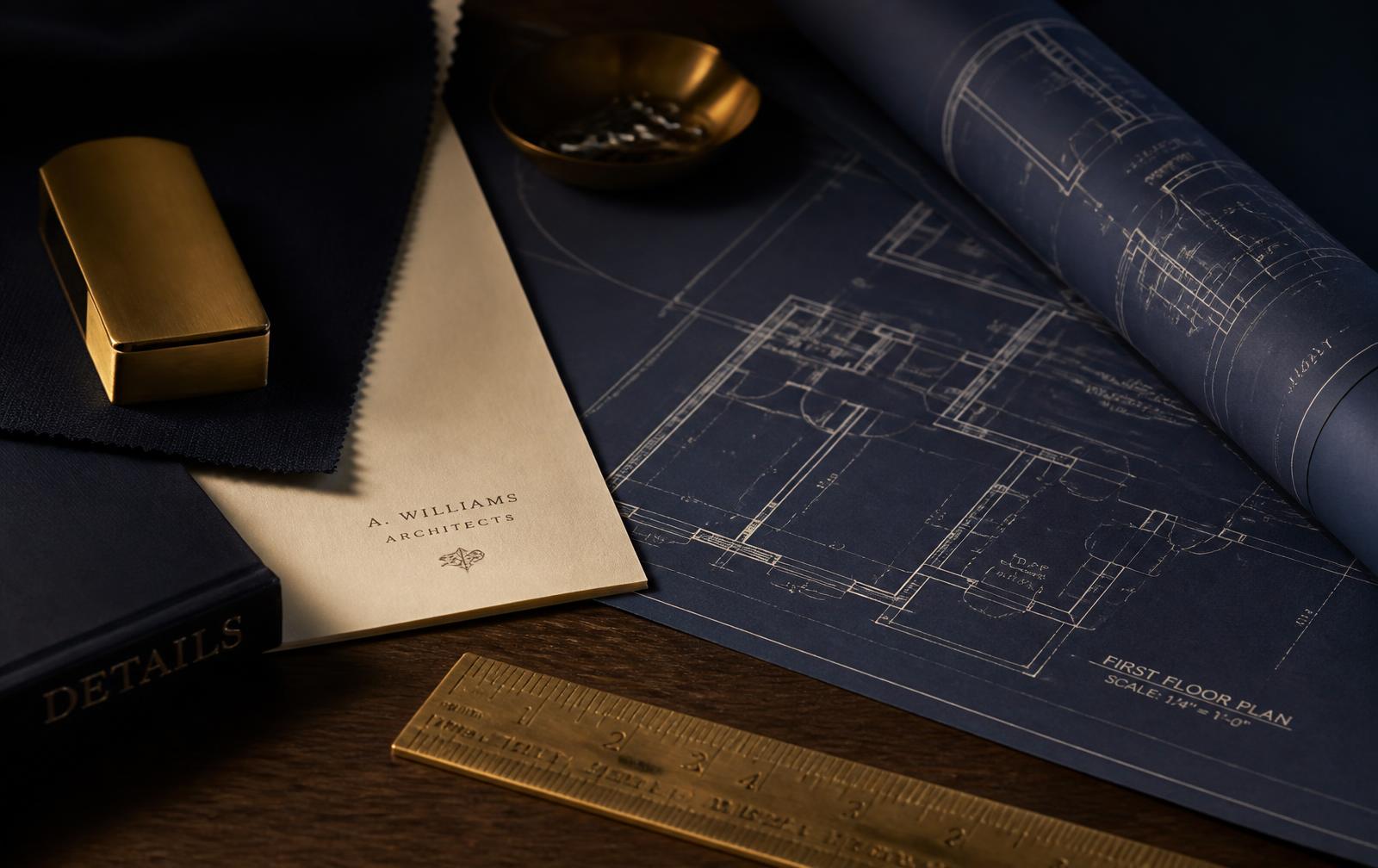 Architectural plans and documents on a dark desk